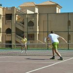 Man and woman playing Tennis on court